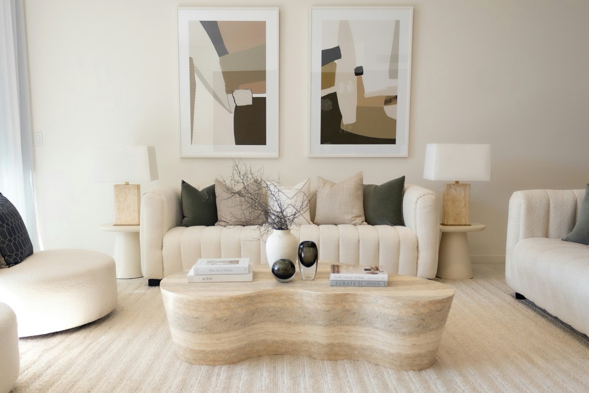 Furnished apartment living room with sofa, coffee table, and large daylit window